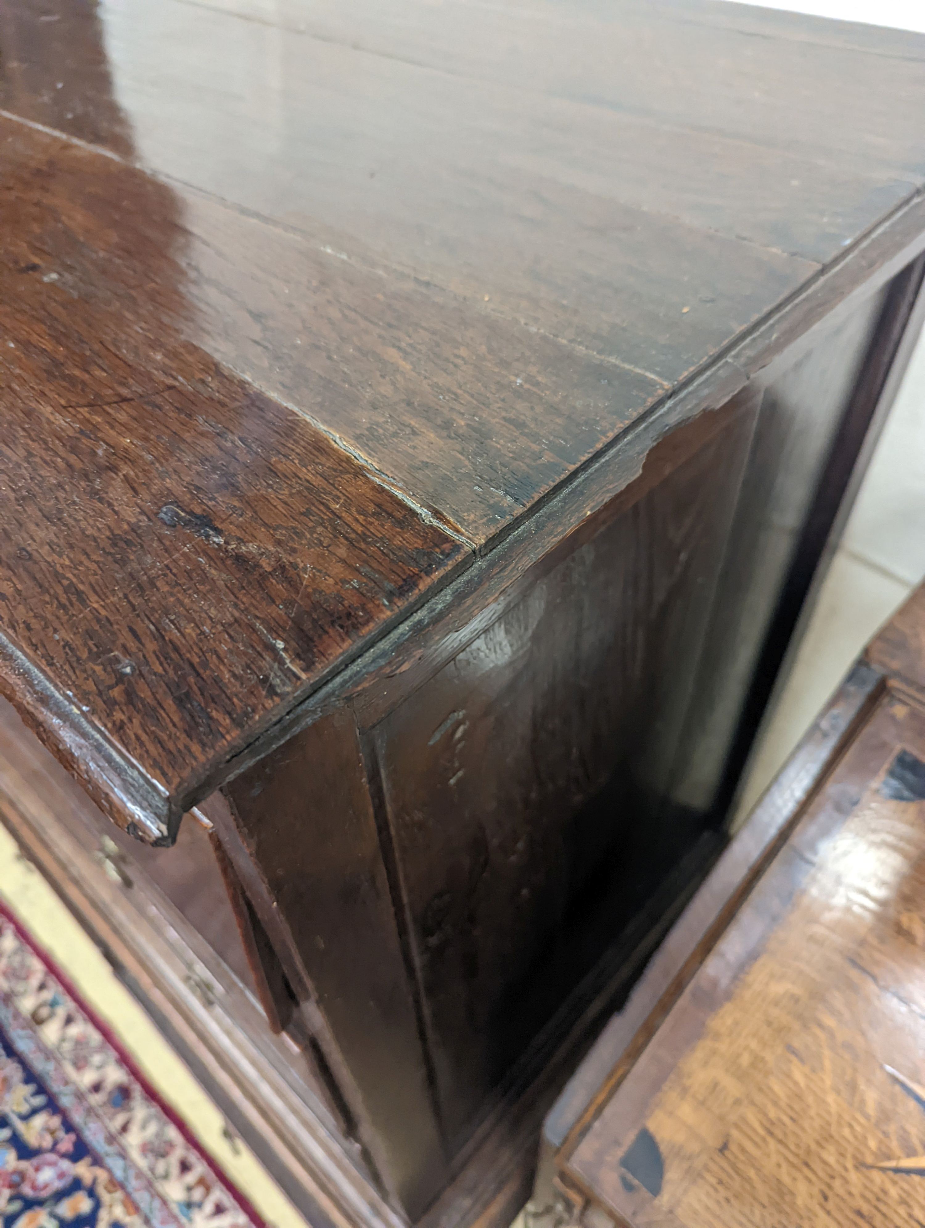 A mid 18th century oak chest on stand, width 89cm, depth 52cm, height 126cm